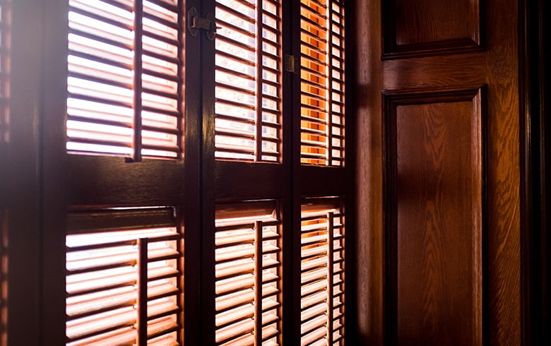 Dark wooden shutters fitted in home