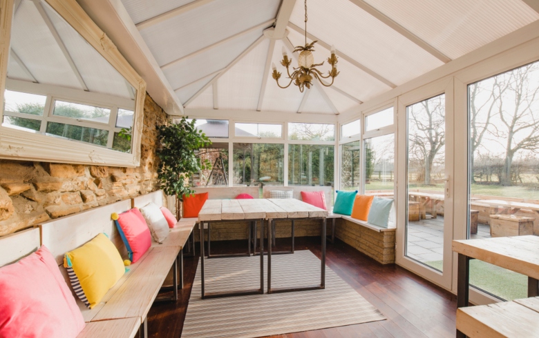 Conservatory with summer cushions and mirror