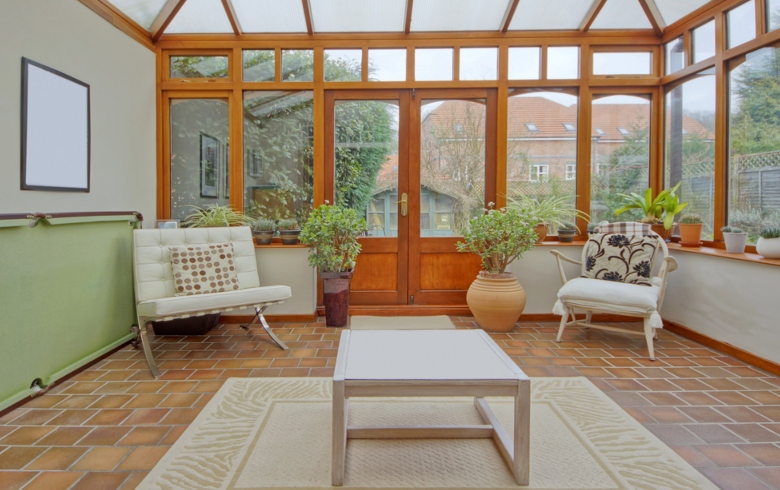 Wooden style conservatory with minimal furniture