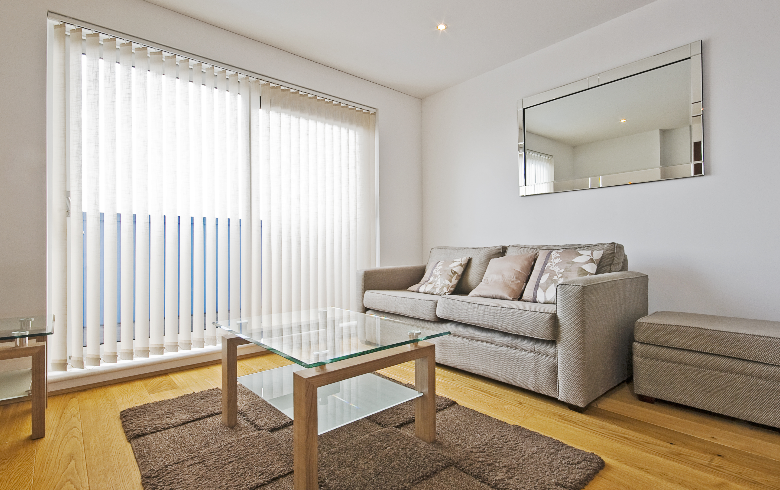 vertical bi-fold door blinds in a neutral-coloured living room