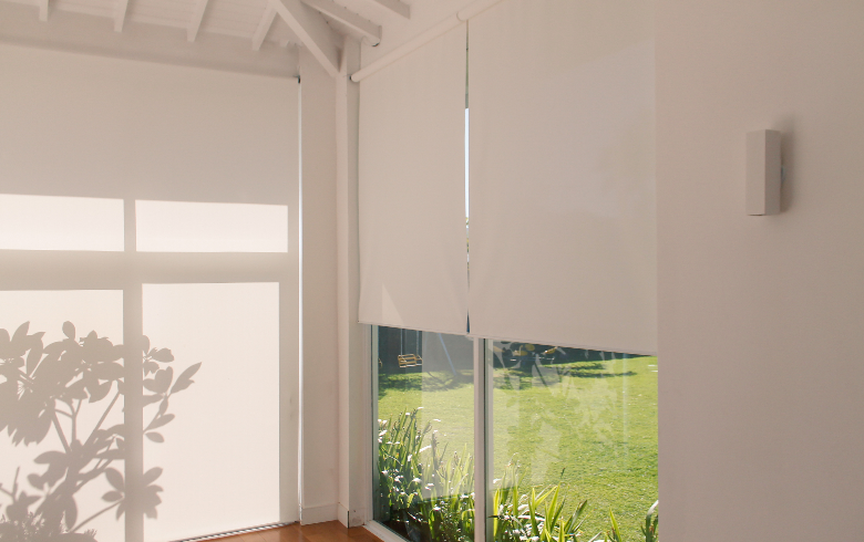 roller bi-fold door blinds in a neutral-coloured room